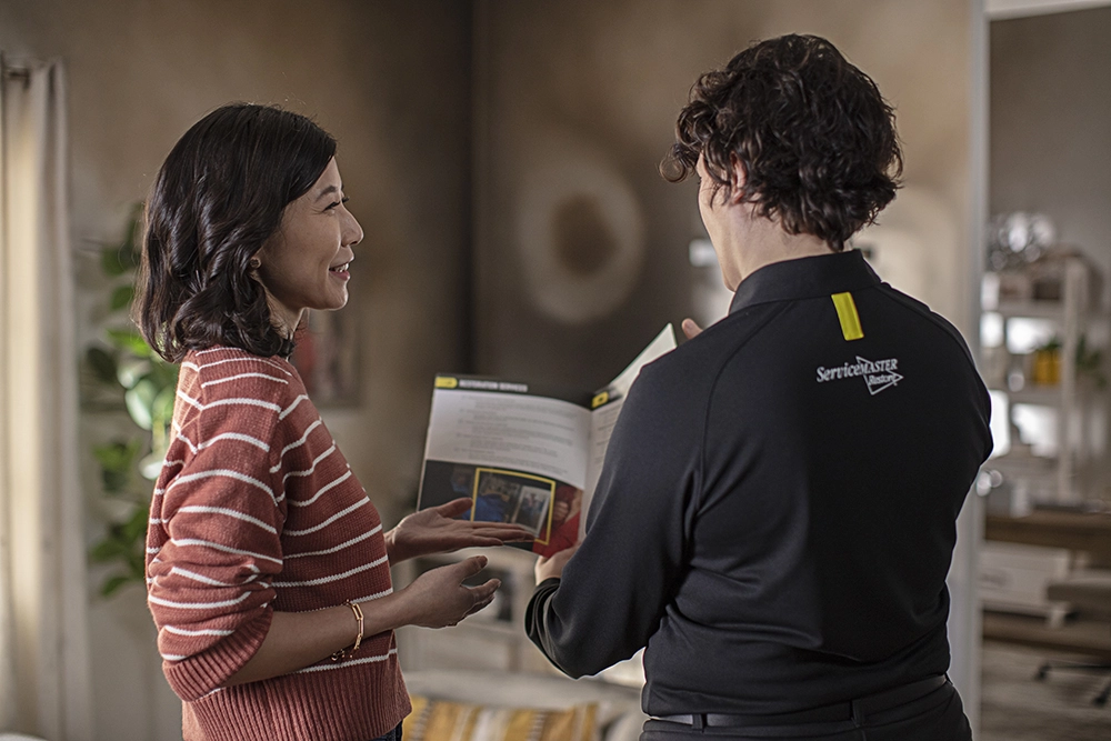 customer and tech reviewing fire damage